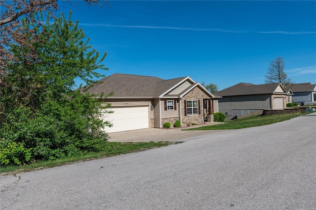 single story home featuring a garage, driveway, and stone siding