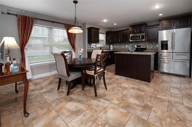dining area with baseboards and recessed lighting