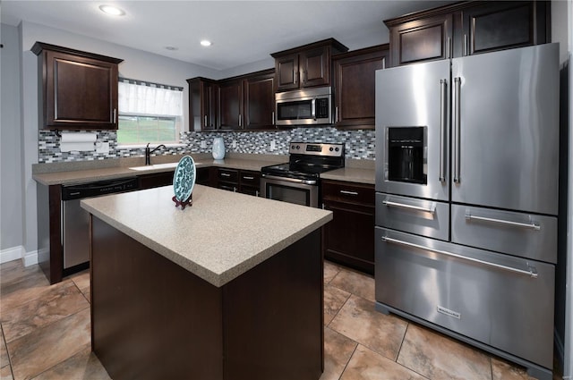 kitchen featuring tasteful backsplash, dark brown cabinetry, stainless steel appliances, and a sink