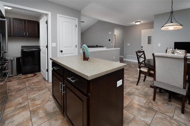 kitchen with visible vents, decorative light fixtures, a kitchen island, light countertops, and dark brown cabinets