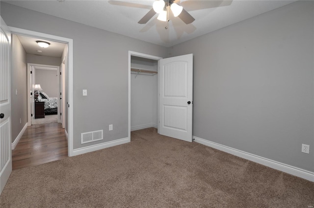 unfurnished bedroom with carpet flooring, a closet, ceiling fan, visible vents, and baseboards