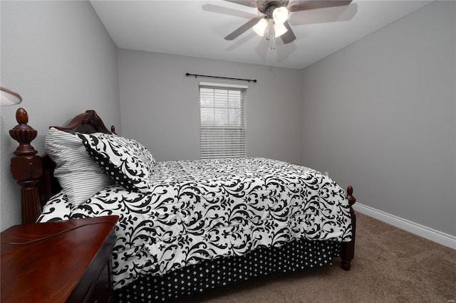 carpeted bedroom with ceiling fan and baseboards