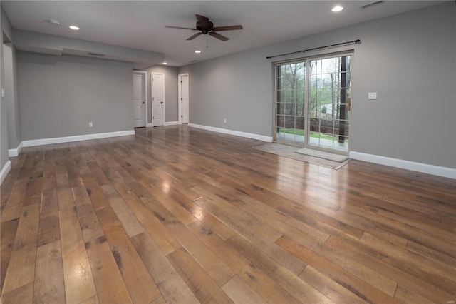 empty room featuring recessed lighting, hardwood / wood-style floors, ceiling fan, and baseboards