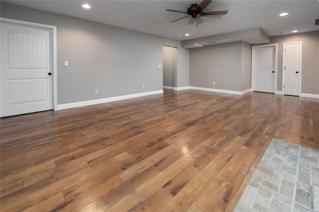 unfurnished living room with recessed lighting, a ceiling fan, visible vents, baseboards, and hardwood / wood-style floors