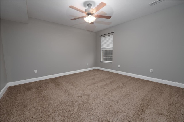 spare room featuring baseboards, visible vents, ceiling fan, and carpet flooring