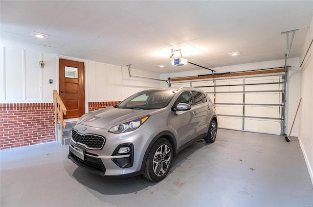 garage with recessed lighting and a garage door opener