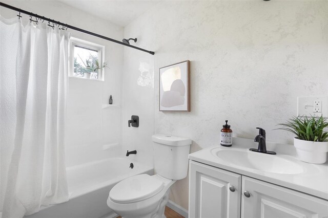 bathroom with vanity, shower / bath combination with curtain, and toilet
