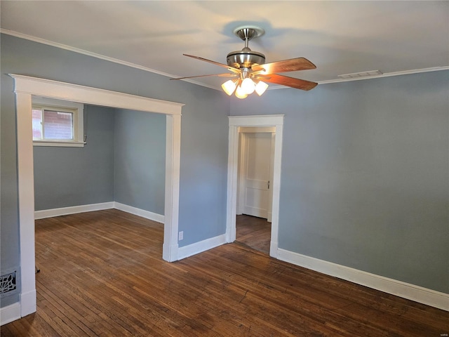 empty room with ornamental molding, visible vents, ceiling fan, and wood-type flooring