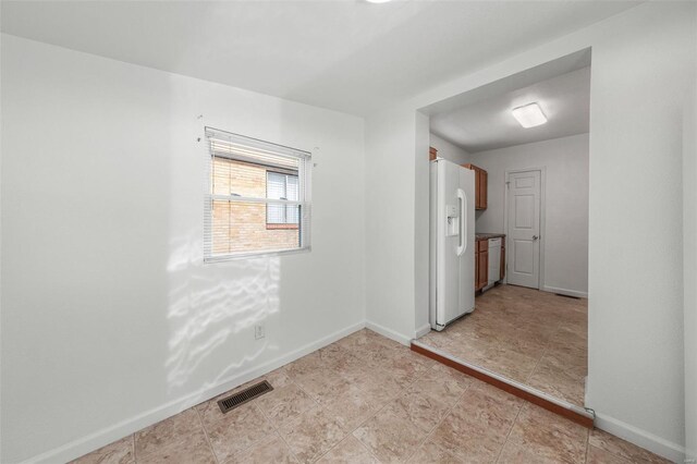 empty room with visible vents and baseboards