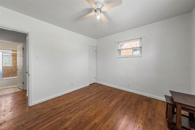 empty room with baseboards, ceiling fan, and a wealth of natural light
