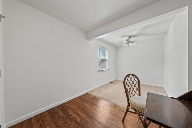 interior space featuring baseboards, ceiling fan, and wood finished floors