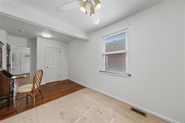 home office with baseboards, ceiling fan, carpet floors, and visible vents