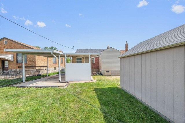 rear view of property with a lawn, fence, and brick siding