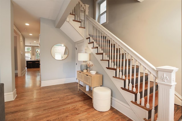staircase with recessed lighting, baseboards, and wood finished floors