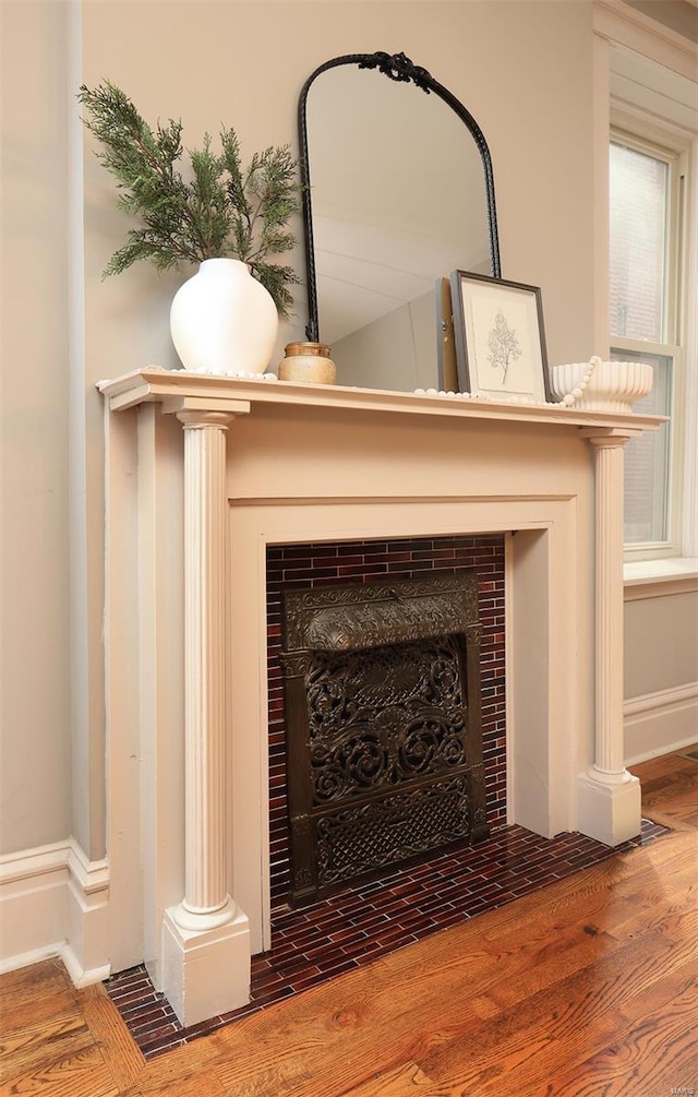 room details featuring wood finished floors and a tile fireplace