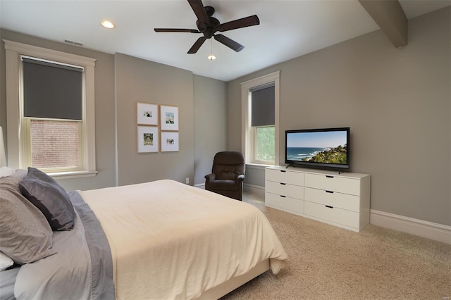 bedroom featuring visible vents, baseboards, carpet floors, and ceiling fan