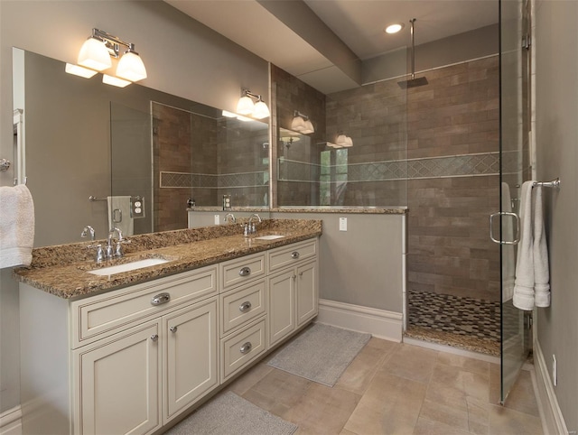 bathroom with a sink, a shower stall, recessed lighting, and double vanity