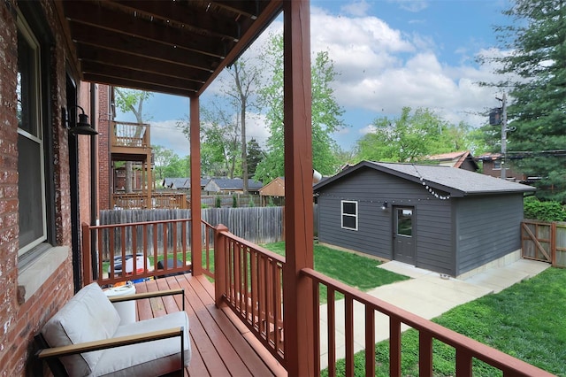 wooden terrace with a yard and a fenced backyard
