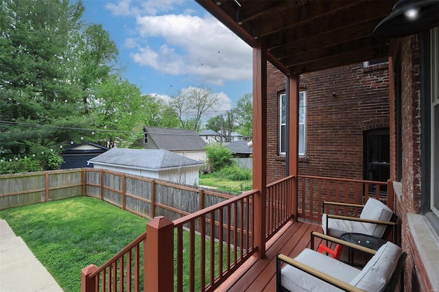 wooden deck featuring a yard and a fenced backyard