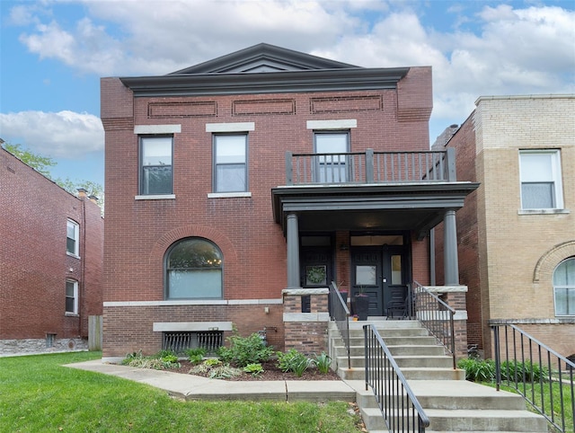 view of front of house featuring brick siding and a balcony