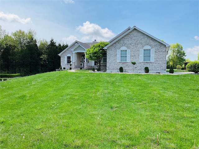 single story home with brick siding and a front yard