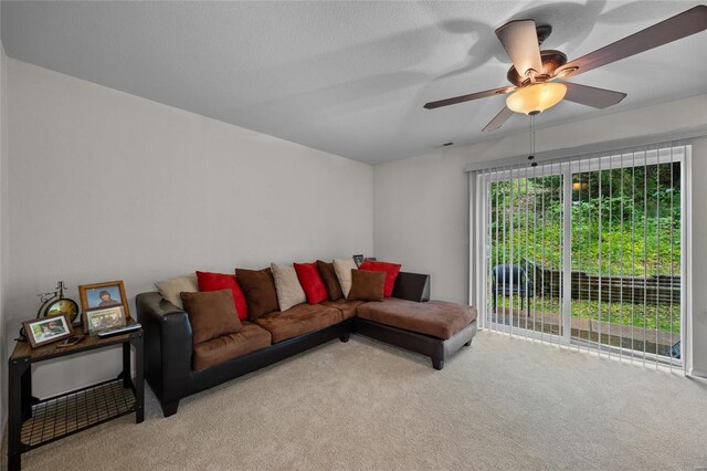 living area featuring carpet flooring and ceiling fan