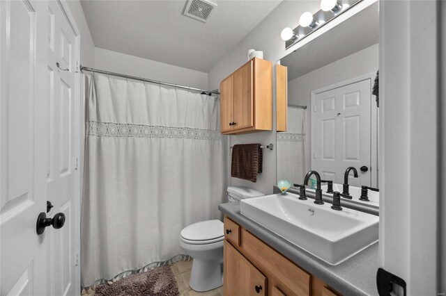 bathroom featuring visible vents, tile patterned flooring, vanity, toilet, and a shower with curtain