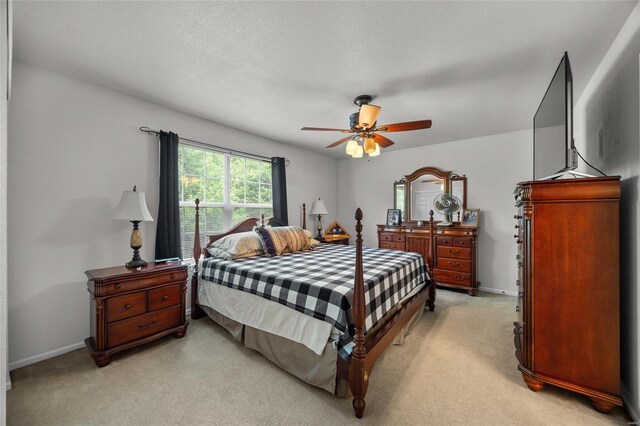 bedroom with baseboards, ceiling fan, and light carpet