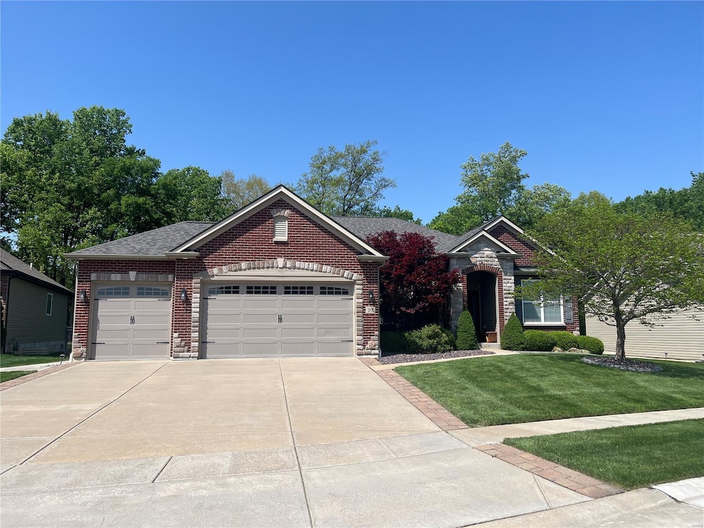 view of front facade featuring a garage, brick siding, a front lawn, concrete driveway, and stone siding
