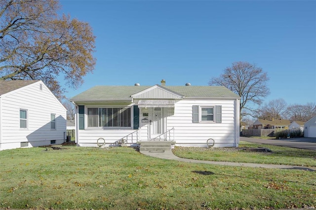 bungalow-style home featuring a front lawn and roof with shingles