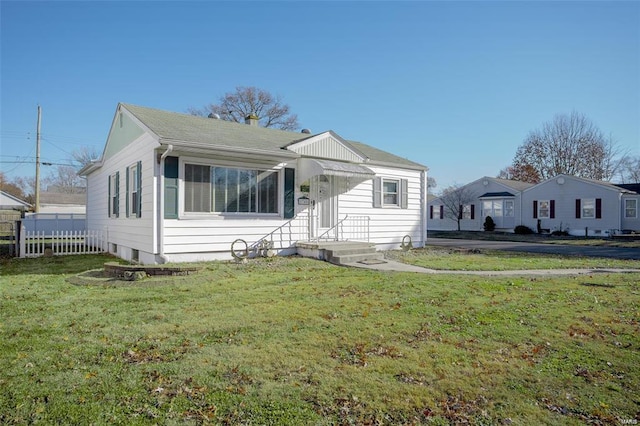 bungalow-style house featuring fence and a front yard