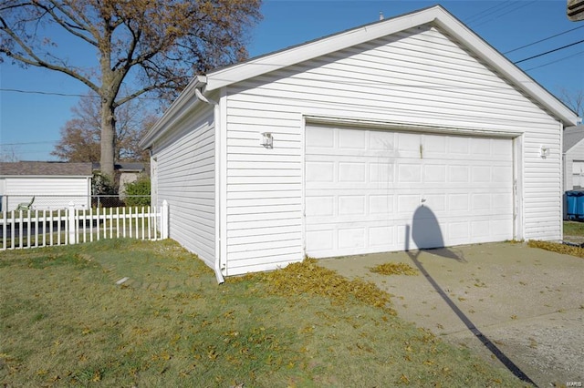 detached garage featuring fence