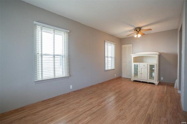 unfurnished living room with ceiling fan and wood finished floors