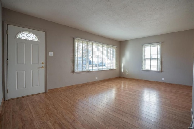 entrance foyer with a textured ceiling and wood finished floors