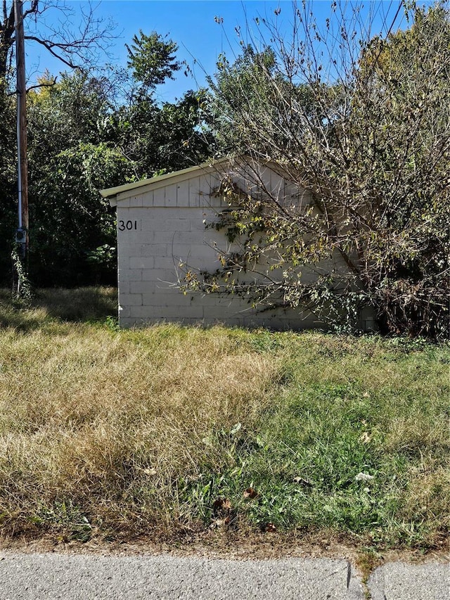 view of property exterior with concrete block siding
