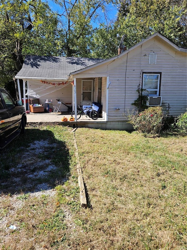 view of side of home featuring a patio and a yard