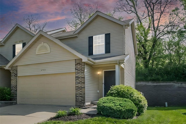 view of front facade featuring concrete driveway, brick siding, and a garage
