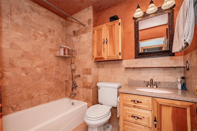 full bathroom featuring bathing tub / shower combination, vanity, toilet, and tile walls
