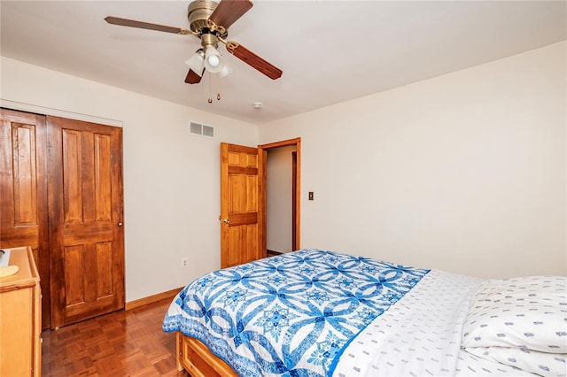 bedroom with visible vents, baseboards, and ceiling fan