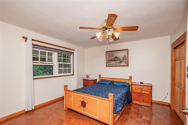 bedroom featuring baseboards and ceiling fan
