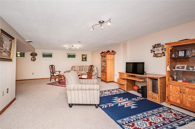 living room with a textured ceiling, visible vents, light carpet, and baseboards