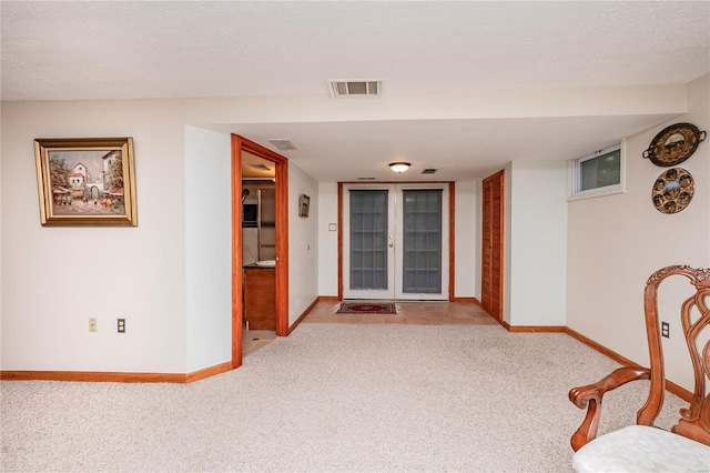 hallway featuring baseboards, carpet flooring, and visible vents