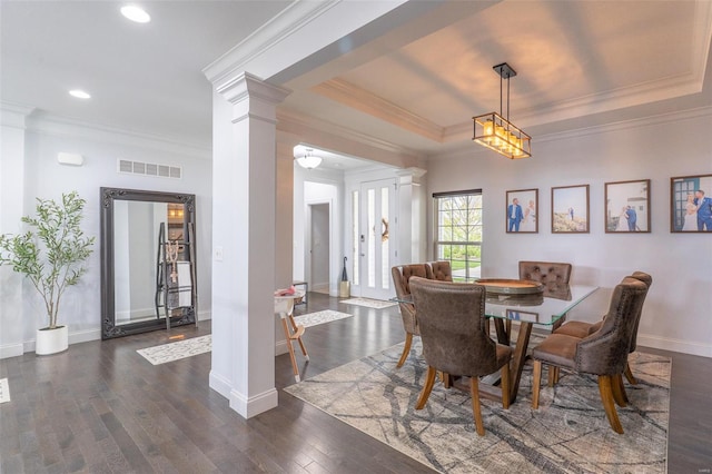 dining area with ornate columns, visible vents, dark wood finished floors, and baseboards