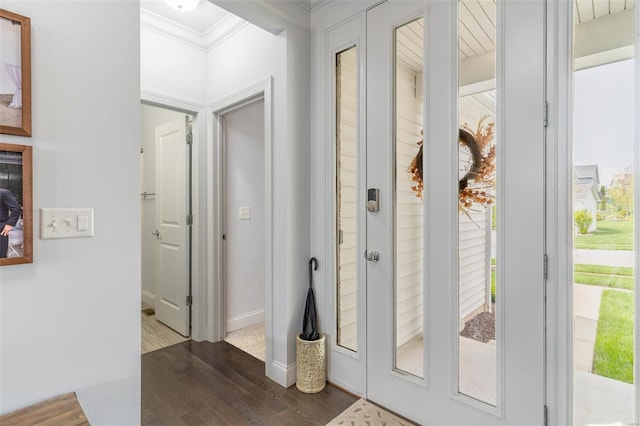 interior space with ornamental molding, dark wood-style flooring, and baseboards