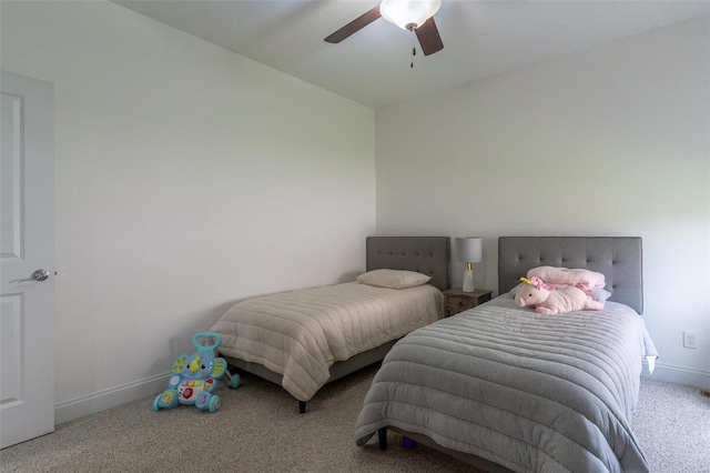 bedroom featuring a ceiling fan, carpet, and baseboards