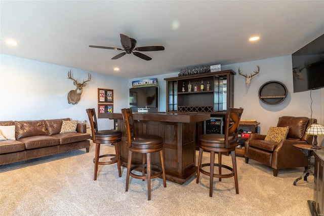 bar with recessed lighting, a ceiling fan, a dry bar, and light carpet