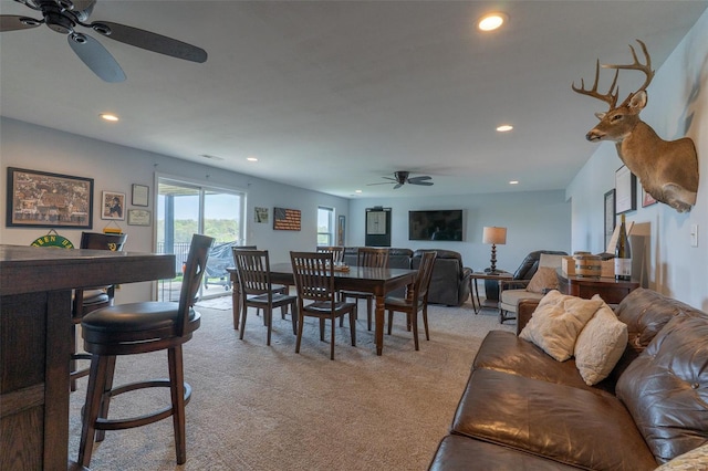 dining room featuring light colored carpet, a ceiling fan, and recessed lighting