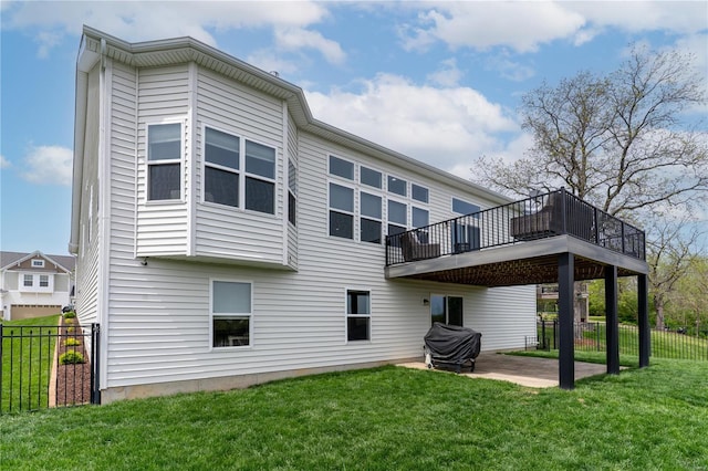 back of property with a lawn, fence, and a patio area