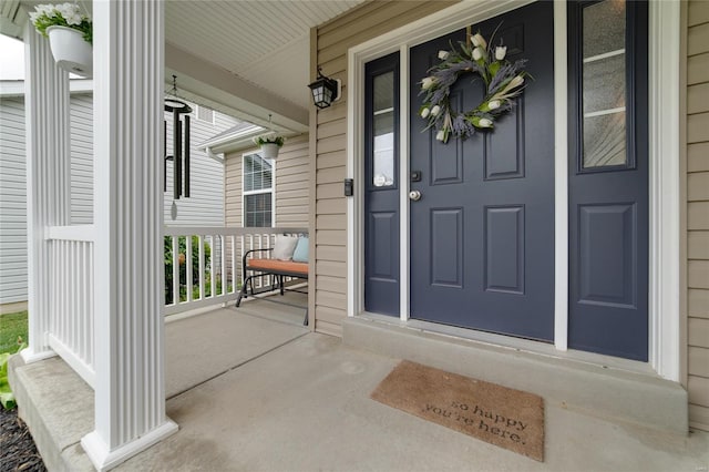 view of exterior entry featuring covered porch