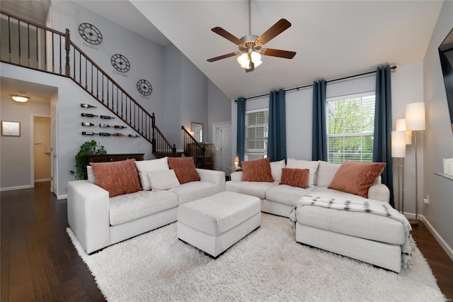 living area featuring high vaulted ceiling, wood finished floors, stairway, and ceiling fan